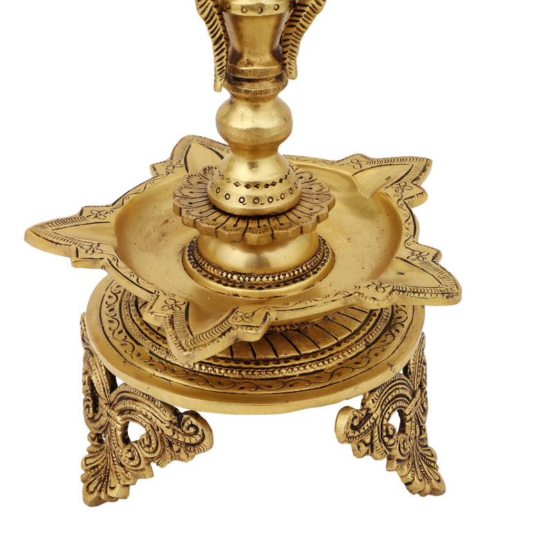 Brass peacock parrot Diya - exquisitely crafted brass oil lamp in the shape of a peacock with parrot motifs, golden finish, decorative home accent, fusion of elegance and vibrancy, traditional Indian Diya, emits a captivating and auspicious glow, perfect for festive occasions and religious ceremonies, enhances spiritual ambiance and decor with a touch of artistic brilliance.