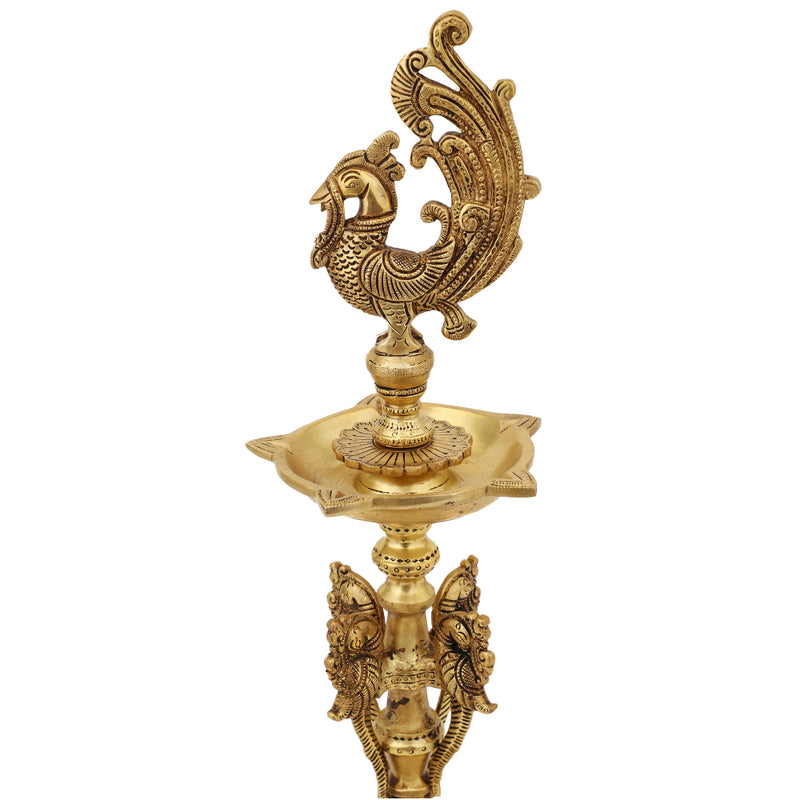 Brass peacock parrot Diya - exquisitely crafted brass oil lamp in the shape of a peacock with parrot motifs, golden finish, decorative home accent, fusion of elegance and vibrancy, traditional Indian Diya, emits a captivating and auspicious glow, perfect for festive occasions and religious ceremonies, enhances spiritual ambiance and decor with a touch of artistic brilliance.