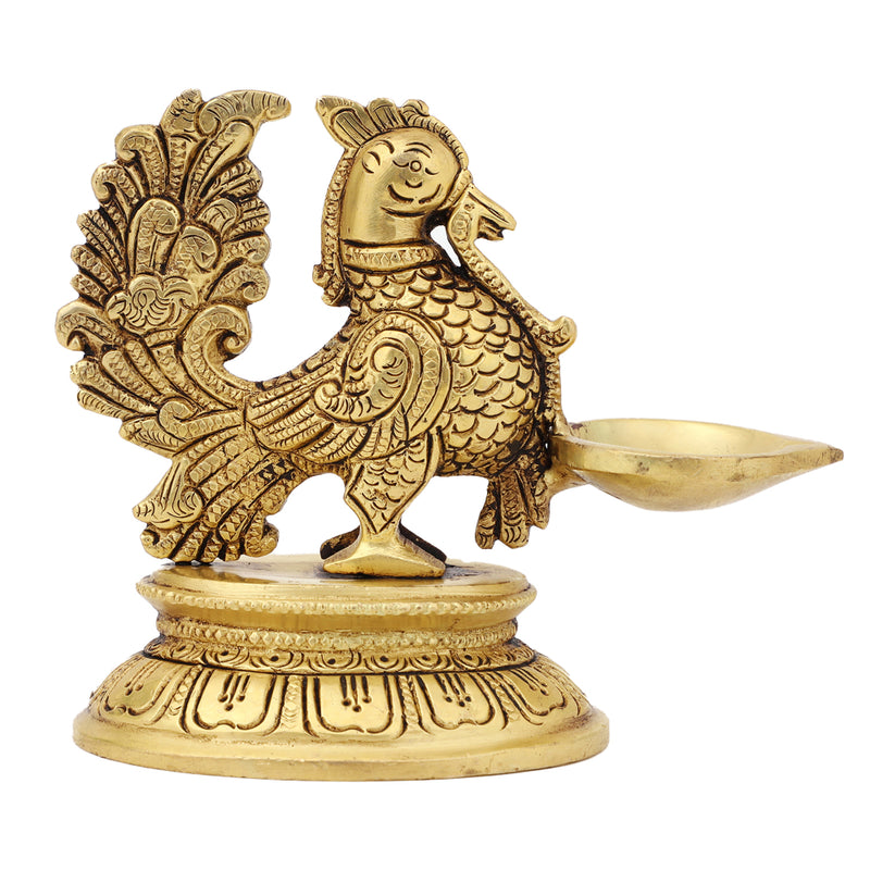 Brass peacock parrot Diya - exquisitely crafted brass oil lamp in the shape of a peacock with parrot motifs, golden finish, decorative home accent, fusion of elegance and vibrancy, traditional Indian Diya, emits a captivating and auspicious glow, perfect for festive occasions and religious ceremonies, enhances spiritual ambiance and decor with a touch of artistic brilliance.