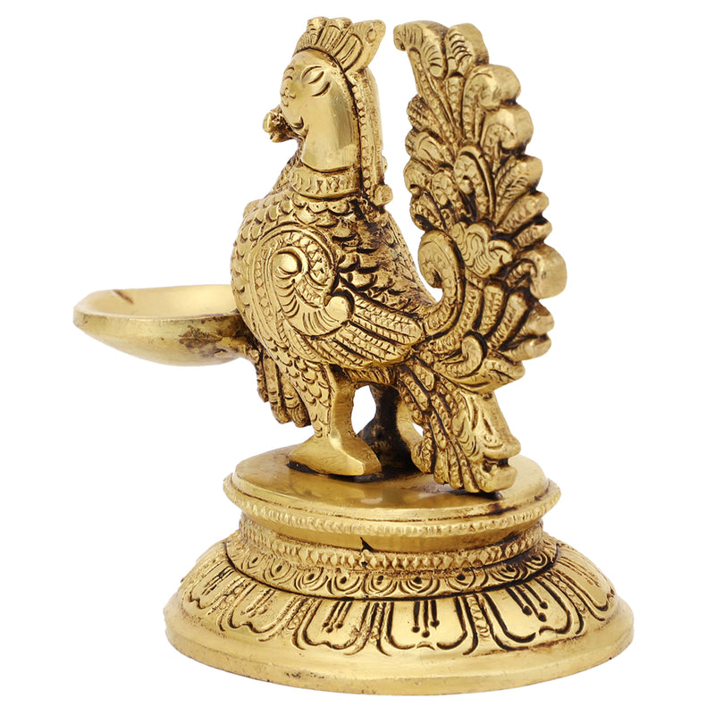 Brass peacock parrot Diya - exquisitely crafted brass oil lamp in the shape of a peacock with parrot motifs, golden finish, decorative home accent, fusion of elegance and vibrancy, traditional Indian Diya, emits a captivating and auspicious glow, perfect for festive occasions and religious ceremonies, enhances spiritual ambiance and decor with a touch of artistic brilliance.