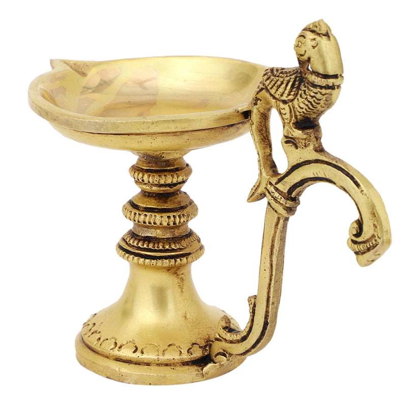 Brass peacock parrot Diya - exquisitely crafted brass oil lamp in the shape of a peacock with parrot motifs, golden finish, decorative home accent, fusion of elegance and vibrancy, traditional Indian Diya, emits a captivating and auspicious glow, perfect for festive occasions and religious ceremonies, enhances spiritual ambiance and decor with a touch of artistic brilliance.