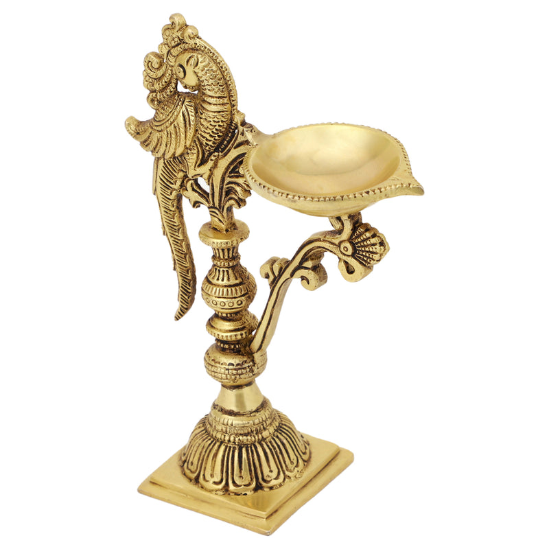 Brass peacock parrot Diya - exquisitely crafted brass oil lamp in the shape of a peacock with parrot motifs, golden finish, decorative home accent, fusion of elegance and vibrancy, traditional Indian Diya, emits a captivating and auspicious glow, perfect for festive occasions and religious ceremonies, enhances spiritual ambiance and decor with a touch of artistic brilliance.