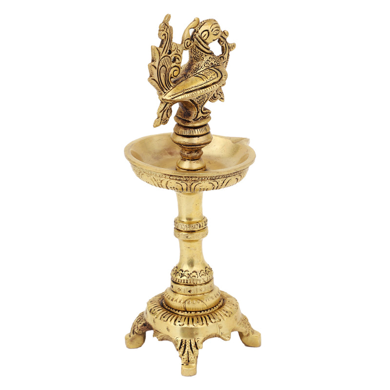 Brass peacock parrot Diya - exquisitely crafted brass oil lamp in the shape of a peacock with parrot motifs, golden finish, decorative home accent, fusion of elegance and vibrancy, traditional Indian Diya, emits a captivating and auspicious glow, perfect for festive occasions and religious ceremonies, enhances spiritual ambiance and decor with a touch of artistic brilliance.