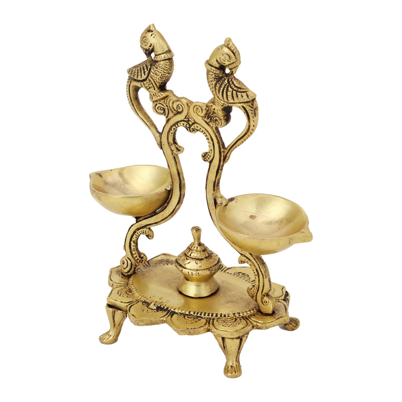 Brass peacock parrot Diya - exquisitely crafted brass oil lamp in the shape of a peacock with parrot motifs, golden finish, decorative home accent, fusion of elegance and vibrancy, traditional Indian Diya, emits a captivating and auspicious glow, perfect for festive occasions and religious ceremonies, enhances spiritual ambiance and decor with a touch of artistic brilliance.