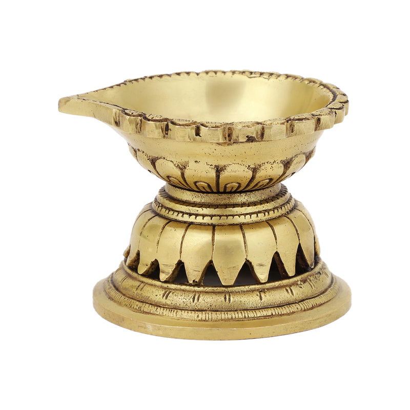 Brass Diya - exquisitely crafted brass oil lamp, traditional design, golden finish, decorative home accent, symbolizes spirituality and enlightenment, emits a warm and tranquil glow, ideal for religious ceremonies and festive occasions, enhances ambiance and decor with a touch of traditional elegance.