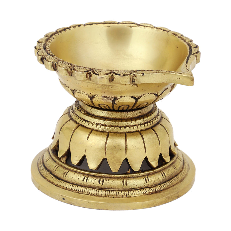 Brass Diya - exquisitely crafted brass oil lamp, traditional design, golden finish, decorative home accent, symbolizes spirituality and enlightenment, emits a warm and tranquil glow, ideal for religious ceremonies and festive occasions, enhances ambiance and decor with a touch of traditional elegance.