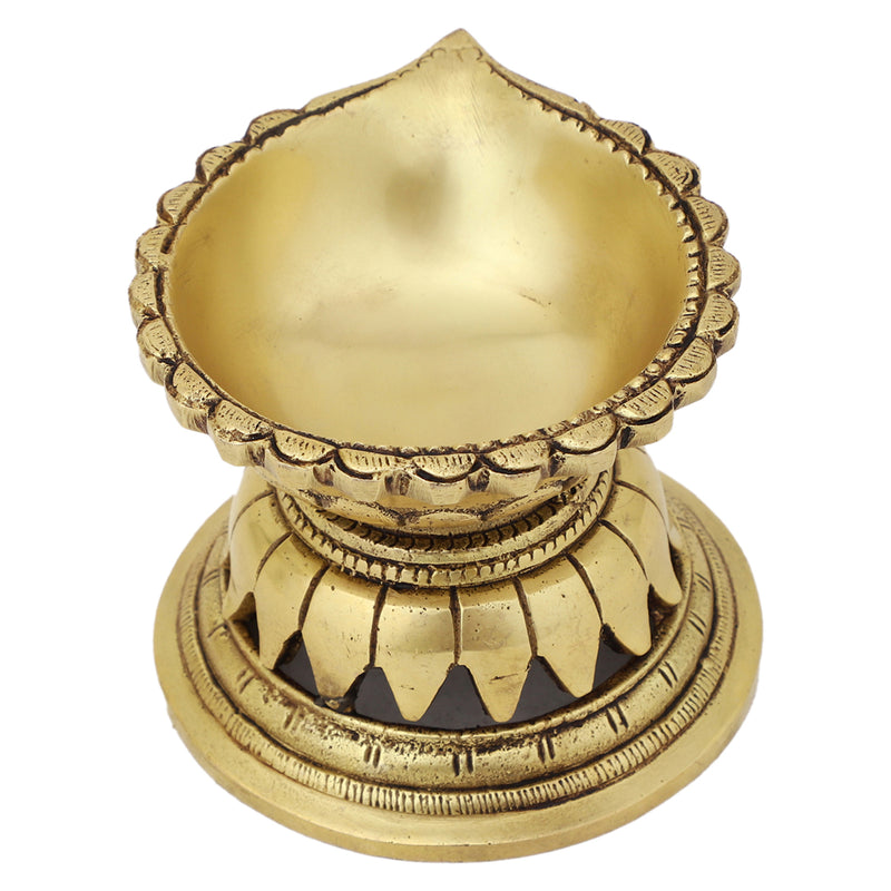 Brass Diya - exquisitely crafted brass oil lamp, traditional design, golden finish, decorative home accent, symbolizes spirituality and enlightenment, emits a warm and tranquil glow, ideal for religious ceremonies and festive occasions, enhances ambiance and decor with a touch of traditional elegance.