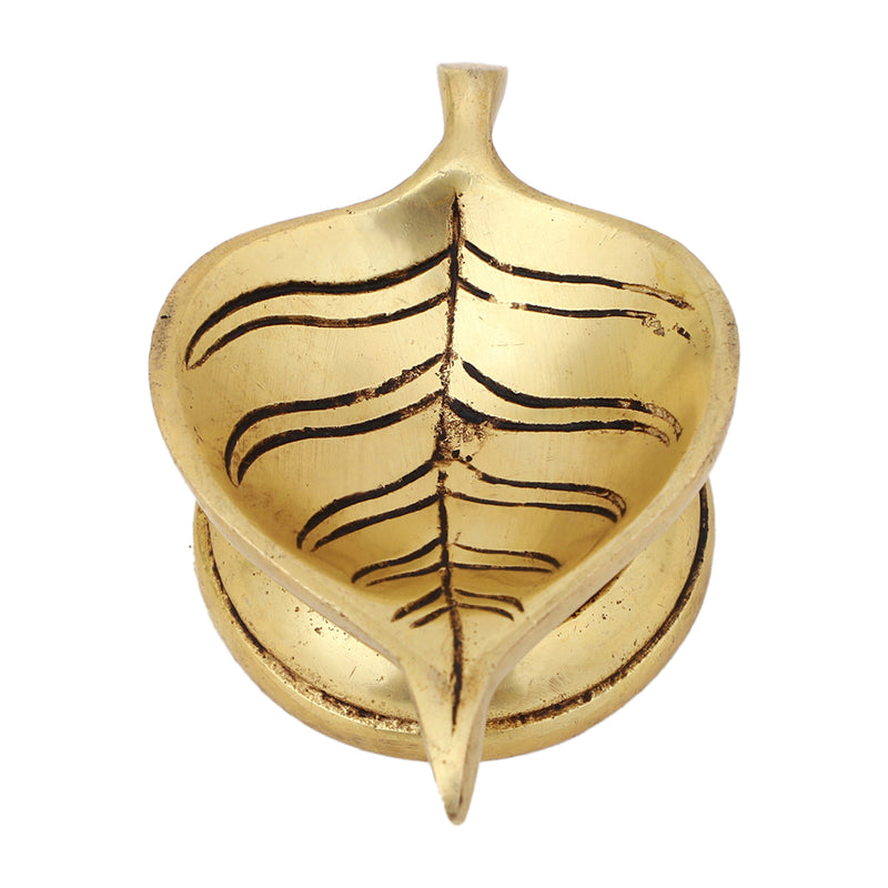 Brass Leaf Diya - elegantly crafted brass oil lamp in the shape of a leaf, golden finish, decorative home accent, inspired by nature's beauty, traditional Indian Diya, emits a soft and serene glow, ideal for religious ceremonies and festive occasions, enhances spiritual ambiance and decor with a touch of natural charm.