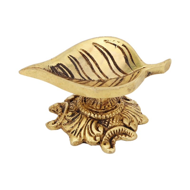 Brass Leaf Diya - elegantly crafted brass oil lamp in the shape of a leaf, golden finish, decorative home accent, inspired by nature's beauty, traditional Indian Diya, emits a soft and serene glow, ideal for religious ceremonies and festive occasions, enhances spiritual ambiance and decor with a touch of natural charm.