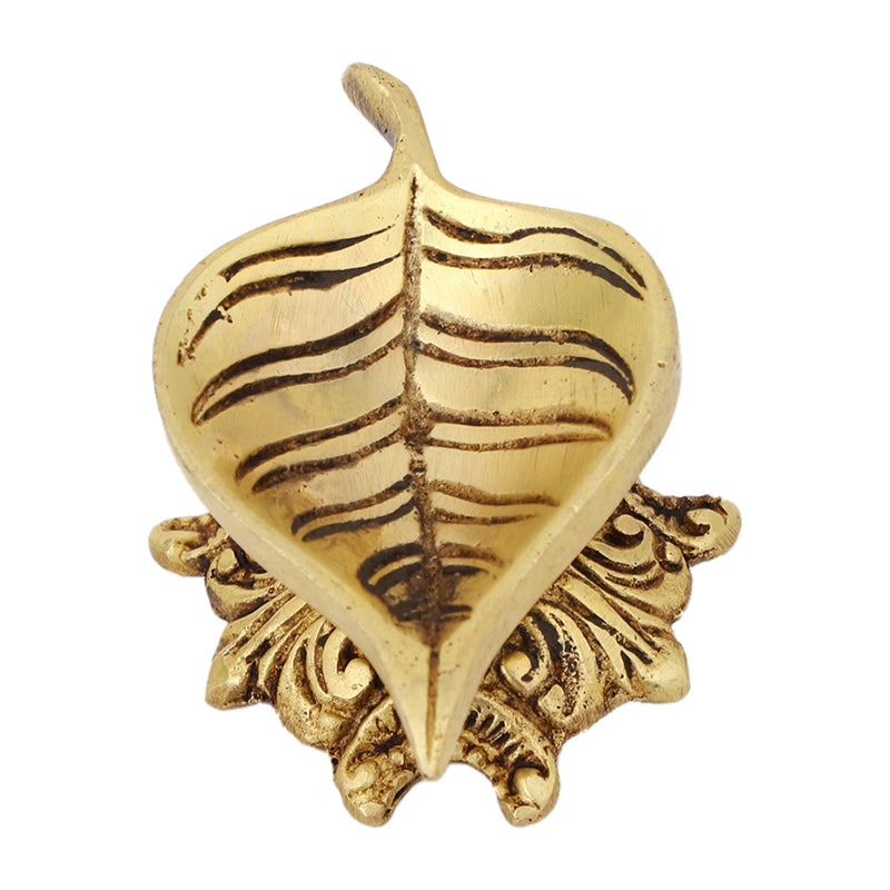 Brass Leaf Diya - elegantly crafted brass oil lamp in the shape of a leaf, golden finish, decorative home accent, inspired by nature's beauty, traditional Indian Diya, emits a soft and serene glow, ideal for religious ceremonies and festive occasions, enhances spiritual ambiance and decor with a touch of natural charm.