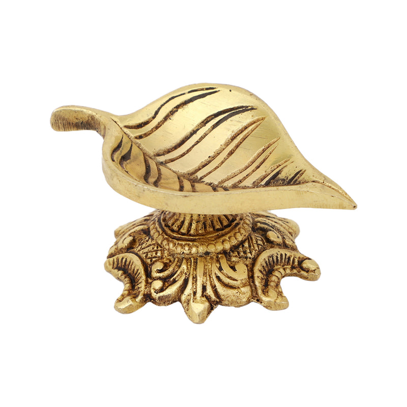 Brass Leaf Diya - elegantly crafted brass oil lamp in the shape of a leaf, golden finish, decorative home accent, inspired by nature's beauty, traditional Indian Diya, emits a soft and serene glow, ideal for religious ceremonies and festive occasions, enhances spiritual ambiance and decor with a touch of natural charm.