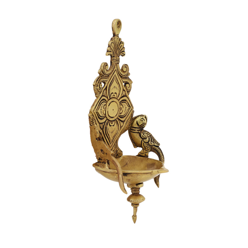 Brass Wall Diya - intricately designed brass oil lamp for wall mounting, golden finish, decorative home accent, traditional Indian Diya, emits a warm and inviting glow, ideal for enhancing wall decor and creating an ambiance of serenity, perfect for religious ceremonies and festive occasions, adds a touch of traditional charm to interior spaces.