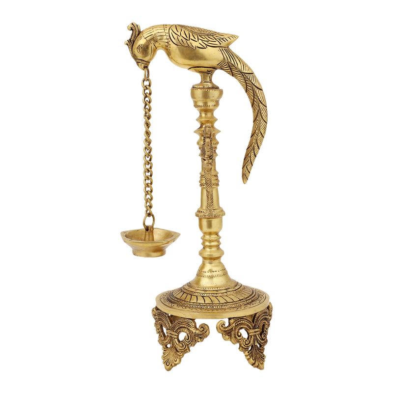 Brass peacock parrot Diya - exquisitely crafted brass oil lamp in the shape of a peacock with parrot motifs, golden finish, decorative home accent, fusion of elegance and vibrancy, traditional Indian Diya, emits a captivating and auspicious glow, perfect for festive occasions and religious ceremonies, enhances spiritual ambiance and decor with a touch of artistic brilliance.