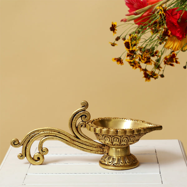 Brass Diya - exquisitely crafted brass oil lamp, traditional design, golden finish, decorative home accent, symbolizes spirituality and enlightenment, emits a warm and tranquil glow, ideal for religious ceremonies and festive occasions, enhances ambiance and decor with a touch of traditional elegance.
