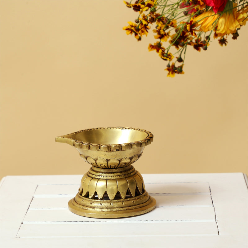 Brass Diya - exquisitely crafted brass oil lamp, traditional design, golden finish, decorative home accent, symbolizes spirituality and enlightenment, emits a warm and tranquil glow, ideal for religious ceremonies and festive occasions, enhances ambiance and decor with a touch of traditional elegance.