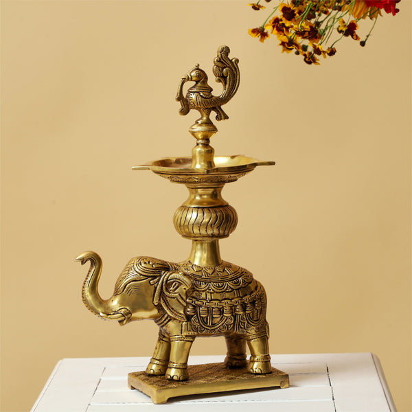 Brass peacock parrot Diya - exquisitely crafted brass oil lamp in the shape of a peacock with parrot motifs, golden finish, decorative home accent, fusion of elegance and vibrancy, traditional Indian Diya, emits a captivating and auspicious glow, perfect for festive occasions and religious ceremonies, enhances spiritual ambiance and decor with a touch of artistic brilliance.