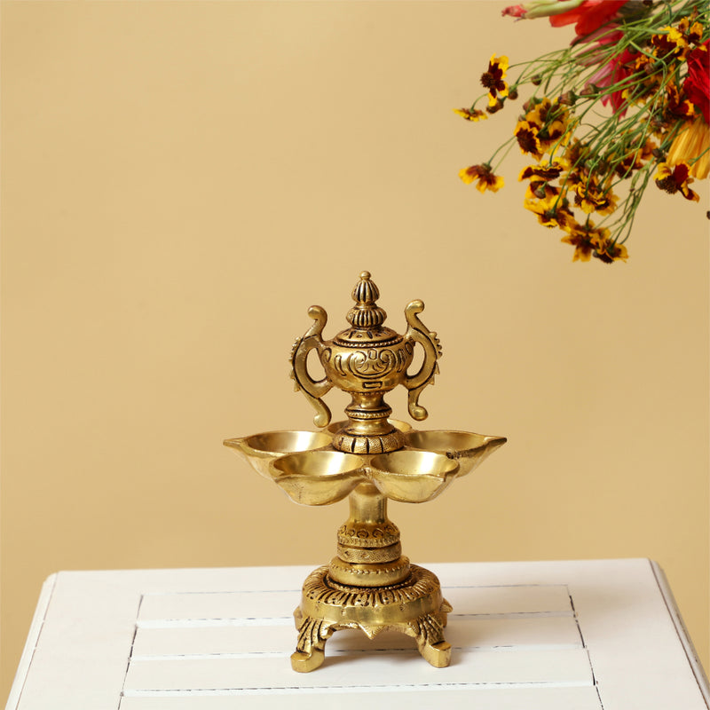 Brass Diya - exquisitely crafted brass oil lamp, traditional design, golden finish, decorative home accent, symbolizes spirituality and enlightenment, emits a warm and tranquil glow, ideal for religious ceremonies and festive occasions, enhances ambiance and decor with a touch of traditional elegance.