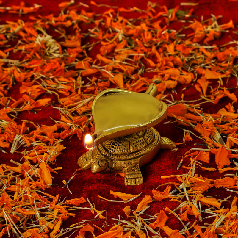 Brass small Akhand Turtle Diya - intricately designed brass oil lamp, compact size, traditional Indian Diya, golden finish, decorative home accent, emits a warm and serene glow, ideal for religious ceremonies and meditation, enhances spiritual ambiance and decor.