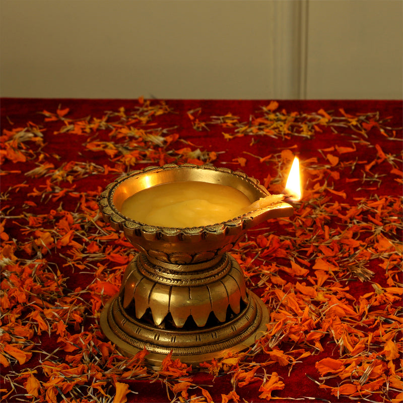 Brass Diya - exquisitely crafted brass oil lamp, traditional design, golden finish, decorative home accent, symbolizes spirituality and enlightenment, emits a warm and tranquil glow, ideal for religious ceremonies and festive occasions, enhances ambiance and decor with a touch of traditional elegance.