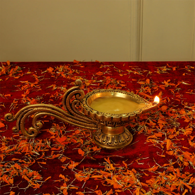 Brass Diya - exquisitely crafted brass oil lamp, traditional design, golden finish, decorative home accent, symbolizes spirituality and enlightenment, emits a warm and tranquil glow, ideal for religious ceremonies and festive occasions, enhances ambiance and decor with a touch of traditional elegance.