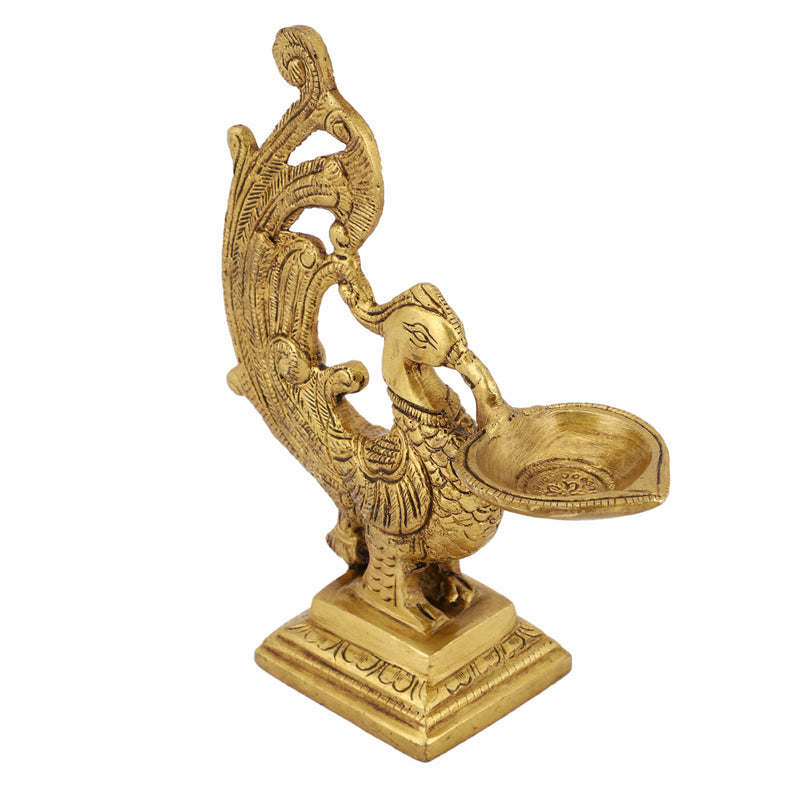 Brass peacock parrot Diya - exquisitely crafted brass oil lamp in the shape of a peacock with parrot motifs, golden finish, decorative home accent, fusion of elegance and vibrancy, traditional Indian Diya, emits a captivating and auspicious glow, perfect for festive occasions and religious ceremonies, enhances spiritual ambiance and decor with a touch of artistic brilliance.