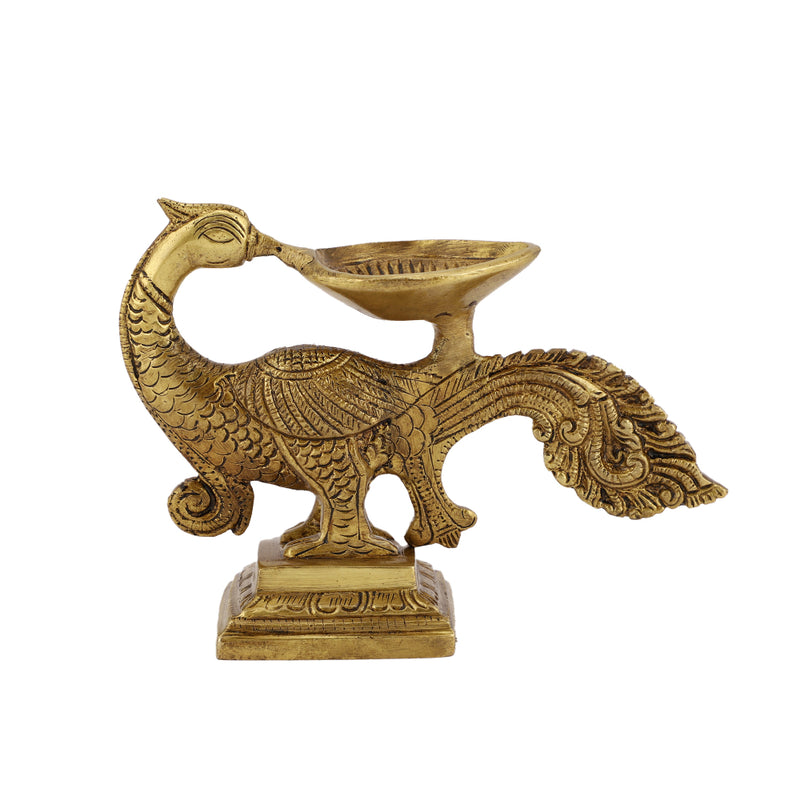 Brass peacock parrot Diya - exquisitely crafted brass oil lamp in the shape of a peacock with parrot motifs, golden finish, decorative home accent, fusion of elegance and vibrancy, traditional Indian Diya, emits a captivating and auspicious glow, perfect for festive occasions and religious ceremonies, enhances spiritual ambiance and decor with a touch of artistic brilliance.