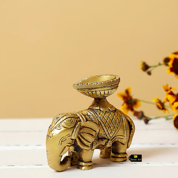 Brass Elephant Diya - intricately designed brass oil lamp in the shape of an elephant, golden finish, decorative home accent, symbolizes strength and wisdom, traditional Indian Diya, emits a warm and enchanting glow, ideal for religious ceremonies and festive occasions, enhances spiritual ambiance and decor