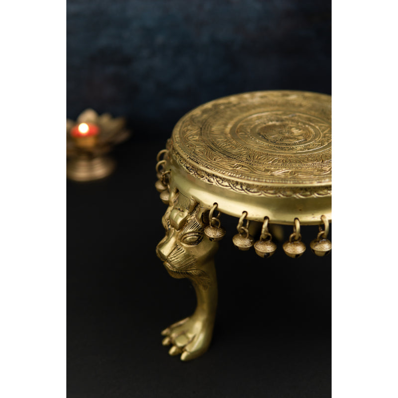 Brass Chowki - intricately carved brass platform, golden finish, perfect for placing deities or sacred objects during religious ceremonies and rituals, enhances the sanctity and beauty of the worship space, symbolizes stability and divine presence, adds a touch of elegance to your home puja setup, a valuable and ornamental addition to your collection of brass religious artifacts and decor.