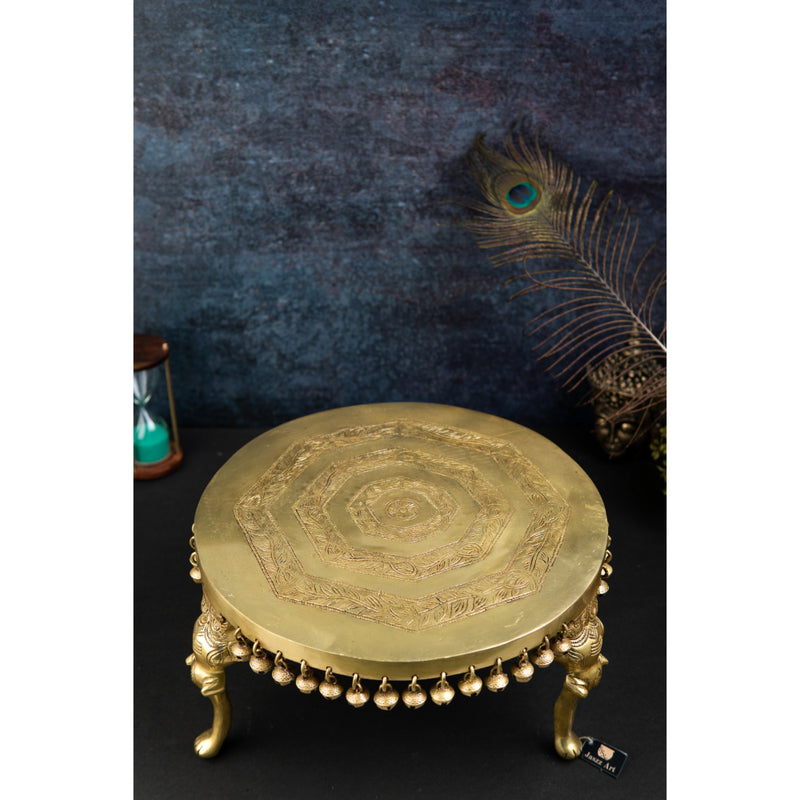 Brass Chowki - intricately carved brass platform, golden finish, perfect for placing deities or sacred objects during religious ceremonies and rituals, enhances the sanctity and beauty of the worship space, symbolizes stability and divine presence, adds a touch of elegance to your home puja setup, a valuable and ornamental addition to your collection of brass religious artifacts and decor.