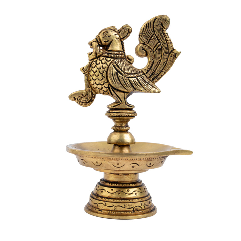 Brass peacock parrot Diya - exquisitely crafted brass oil lamp in the shape of a peacock with parrot motifs, golden finish, decorative home accent, fusion of elegance and vibrancy, traditional Indian Diya, emits a captivating and auspicious glow, perfect for festive occasions and religious ceremonies, enhances spiritual ambiance and decor with a touch of artistic brilliance.