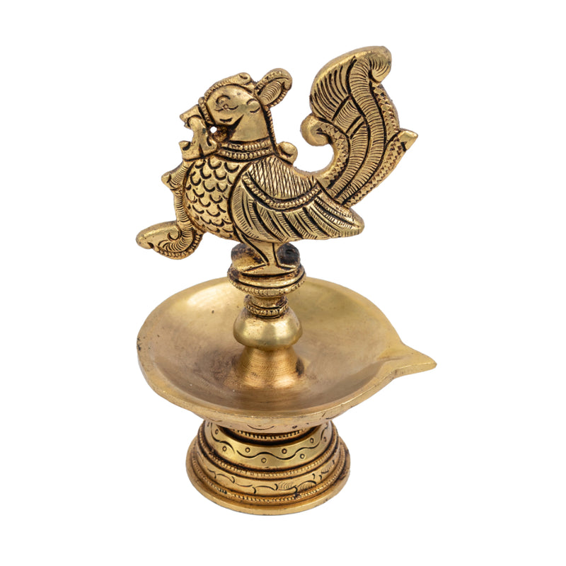 Brass peacock parrot Diya - exquisitely crafted brass oil lamp in the shape of a peacock with parrot motifs, golden finish, decorative home accent, fusion of elegance and vibrancy, traditional Indian Diya, emits a captivating and auspicious glow, perfect for festive occasions and religious ceremonies, enhances spiritual ambiance and decor with a touch of artistic brilliance.