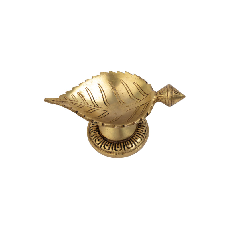 Brass Leaf Diya - elegantly crafted brass oil lamp in the shape of a leaf, golden finish, decorative home accent, inspired by nature's beauty, traditional Indian Diya, emits a soft and serene glow, ideal for religious ceremonies and festive occasions, enhances spiritual ambiance and decor with a touch of natural charm.