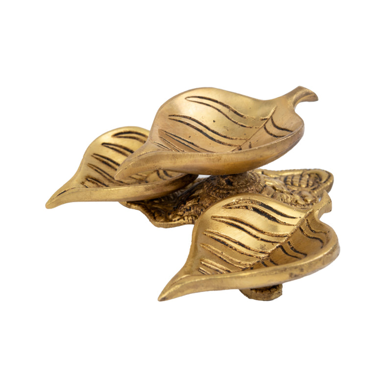 Brass Leaf Diya - elegantly crafted brass oil lamp in the shape of a leaf, golden finish, decorative home accent, inspired by nature's beauty, traditional Indian Diya, emits a soft and serene glow, ideal for religious ceremonies and festive occasions, enhances spiritual ambiance and decor with a touch of natural charm.