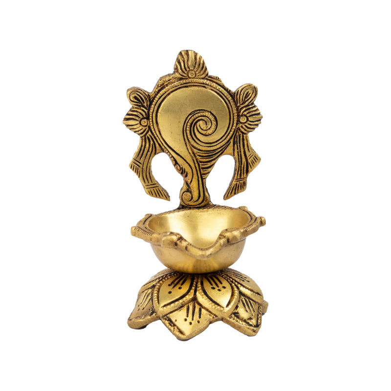 Brass Shank Diya - intricately designed brass oil lamp in the shape of a conch shell, golden finish, decorative home accent, symbolizes purity and spirituality, traditional Indian Diya, emits a radiant and calming glow, perfect for religious ceremonies and meditation, enhances spiritual ambiance and decor with a touch of serenity.