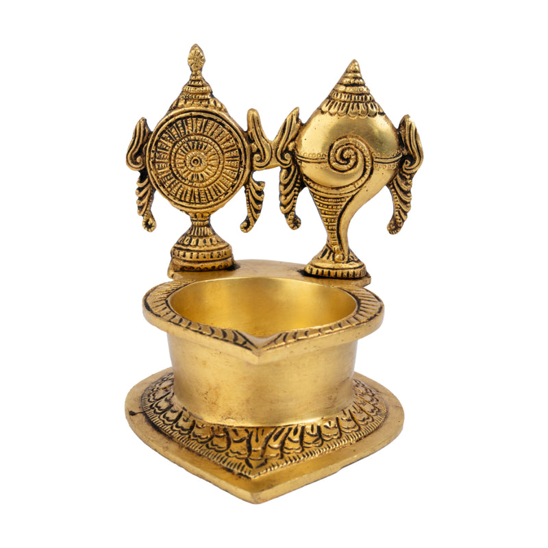 Brass Shank Chakra Diya - beautifully crafted brass oil lamp in the shape of a conch shell with chakra design, golden finish, decorative home accent, symbolizes purity and spiritual energy, traditional Indian Diya, emits a divine and serene glow, ideal for religious ceremonies and meditation, enhances spiritual ambiance and decor with a touch of sacredness.