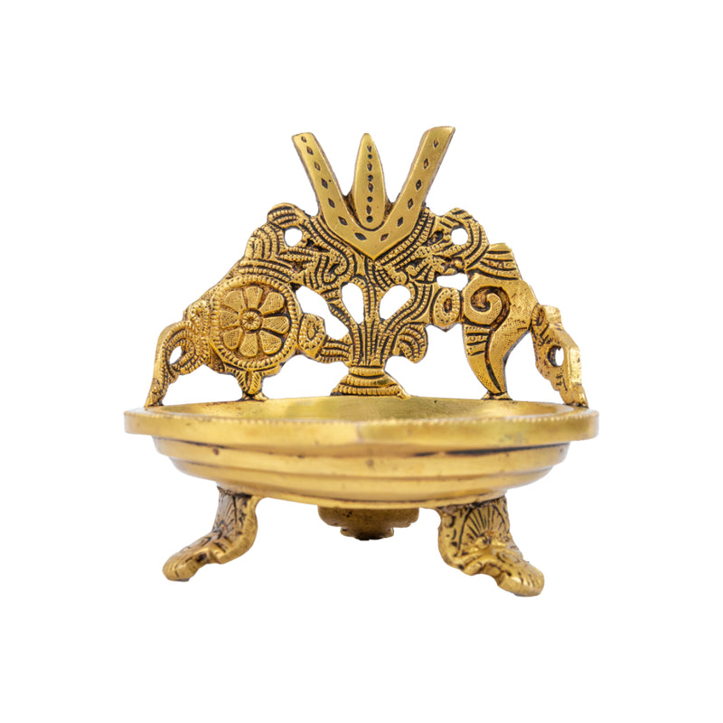 Brass Shank Trishul Chakra Diya - intricately designed brass oil lamp in the shape of a conch shell with trishul (trident) and chakra motifs, golden finish, decorative home accent, symbolizes divine energy and protection, traditional Indian Diya, emits a sacred and luminous glow, perfect for religious rituals and spiritual practices, enhances spiritual ambiance and decor with a touch of auspiciousness.