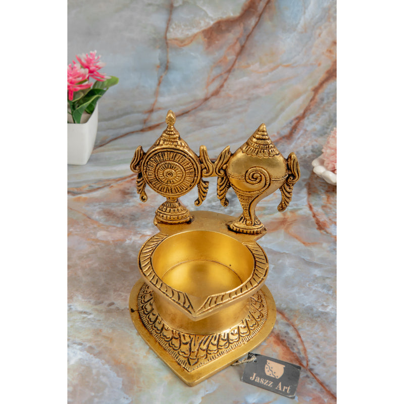 Brass Shank Chakra Diya - beautifully crafted brass oil lamp in the shape of a conch shell with chakra design, golden finish, decorative home accent, symbolizes purity and spiritual energy, traditional Indian Diya, emits a divine and serene glow, ideal for religious ceremonies and meditation, enhances spiritual ambiance and decor with a touch of sacredness.