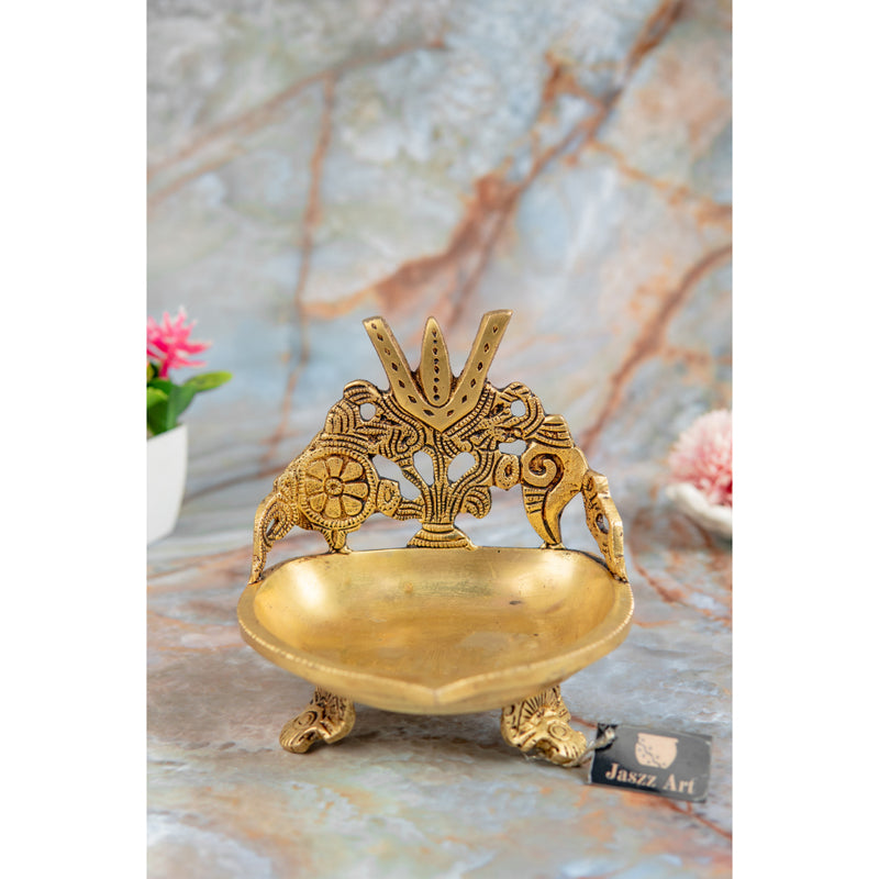 Brass Shank Trishul Chakra Diya - intricately designed brass oil lamp in the shape of a conch shell with trishul (trident) and chakra motifs, golden finish, decorative home accent, symbolizes divine energy and protection, traditional Indian Diya, emits a sacred and luminous glow, perfect for religious rituals and spiritual practices, enhances spiritual ambiance and decor with a touch of auspiciousness.