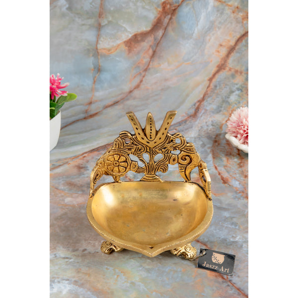 Brass Shank Trishul Chakra Diya - intricately designed brass oil lamp in the shape of a conch shell with trishul (trident) and chakra motifs, golden finish, decorative home accent, symbolizes divine energy and protection, traditional Indian Diya, emits a sacred and luminous glow, perfect for religious rituals and spiritual practices, enhances spiritual ambiance and decor with a touch of auspiciousness.