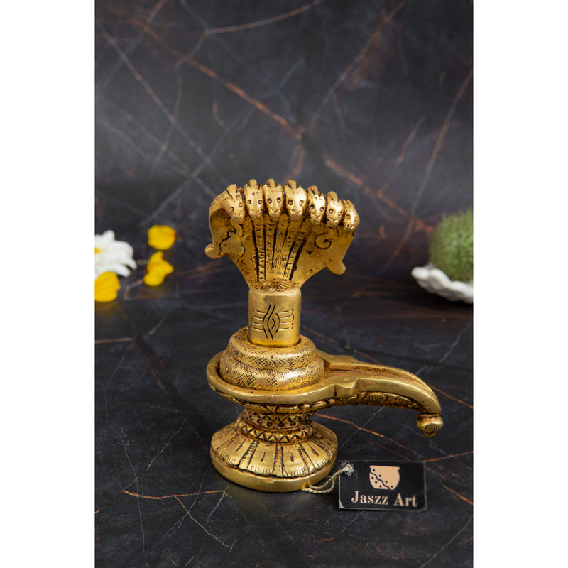 Brass Shivling - intricately crafted brass Shivling (Shiva Lingam), golden finish, sacred symbol of Lord Shiva, perfect for worship and meditation, ideal for creating a divine ambiance in your home or temple, symbolizes the cosmic energy and represents the formless nature of Lord Shiva, enhances spiritual practices and fosters a sense of reverence, a beautiful and sacred addition to your collection of brass artifacts.