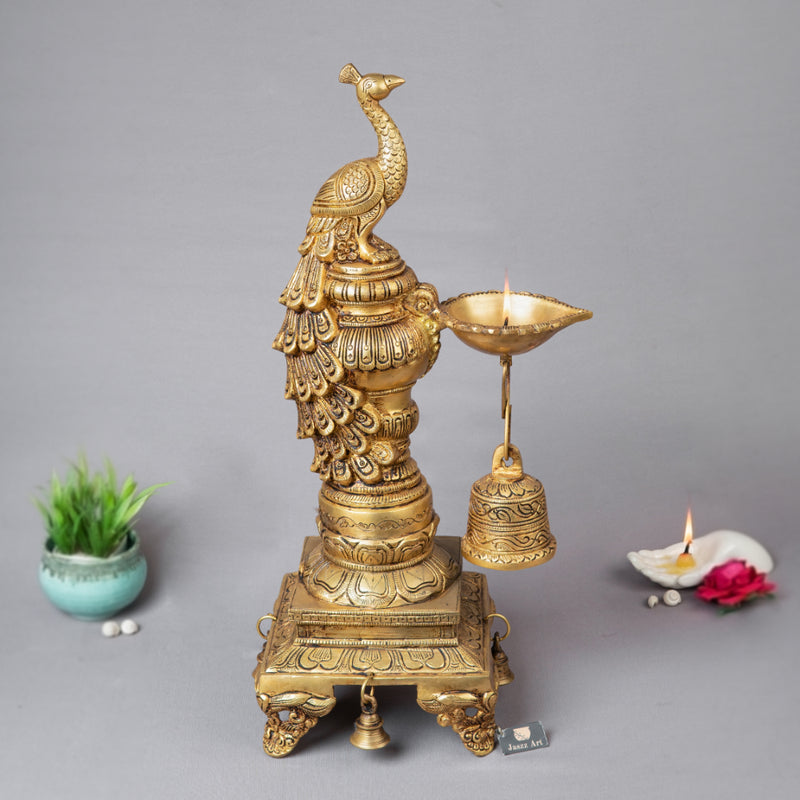 Brass peacock parrot Diya - exquisitely crafted brass oil lamp in the shape of a peacock with parrot motifs, golden finish, decorative home accent, fusion of elegance and vibrancy, traditional Indian Diya, emits a captivating and auspicious glow, perfect for festive occasions and religious ceremonies, enhances spiritual ambiance and decor with a touch of artistic brilliance.