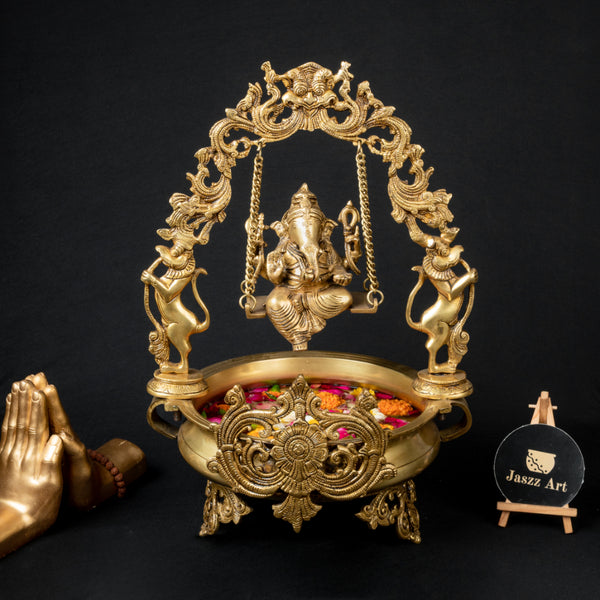 Brass Lakshmi & Ganesh Ji Urli - intricately crafted brass decorative bowl featuring idols of Goddess Lakshmi and Lord Ganesh, golden finish, traditional Indian Urli, versatile home accent, ideal for floating flower petals or candles, symbolizes prosperity and blessings, adds a touch of divinity and cultural richness to any space, perfect for creating an auspicious ambiance and enhancing interior decor, a timeless piece of art for both indoor and outdoor settings.