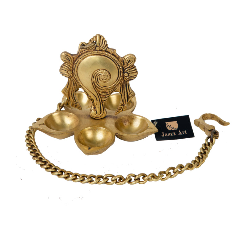 Brass Wall Diya - intricately designed brass oil lamp for wall mounting, golden finish, decorative home accent, traditional Indian Diya, emits a warm and inviting glow, ideal for enhancing wall decor and creating an ambiance of serenity, perfect for religious ceremonies and festive occasions, adds a touch of traditional charm to interior spaces.