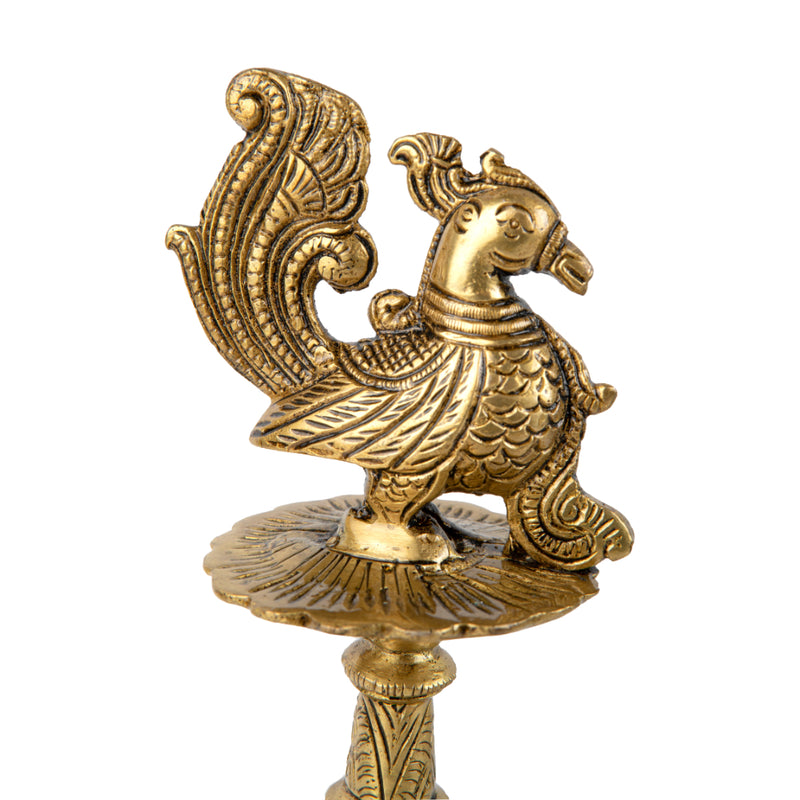 Brass peacock parrot Diya - exquisitely crafted brass oil lamp in the shape of a peacock with parrot motifs, golden finish, decorative home accent, fusion of elegance and vibrancy, traditional Indian Diya, emits a captivating and auspicious glow, perfect for festive occasions and religious ceremonies, enhances spiritual ambiance and decor with a touch of artistic brilliance.