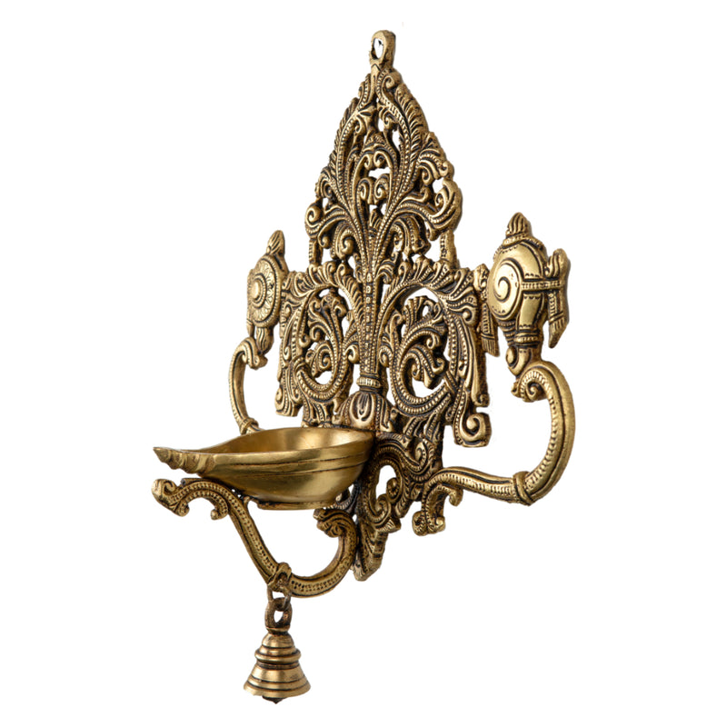 Brass Wall Diya - intricately designed brass oil lamp for wall mounting, golden finish, decorative home accent, traditional Indian Diya, emits a warm and inviting glow, ideal for enhancing wall decor and creating an ambiance of serenity, perfect for religious ceremonies and festive occasions, adds a touch of traditional charm to interior spaces.