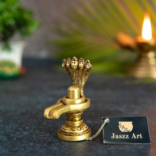 Brass Shivling - intricately crafted brass Shivling (Shiva Lingam), golden finish, sacred symbol of Lord Shiva, perfect for worship and meditation, ideal for creating a divine ambiance in your home or temple, symbolizes the cosmic energy and represents the formless nature of Lord Shiva, enhances spiritual practices and fosters a sense of reverence, a beautiful and sacred addition to your collection of brass artifacts.