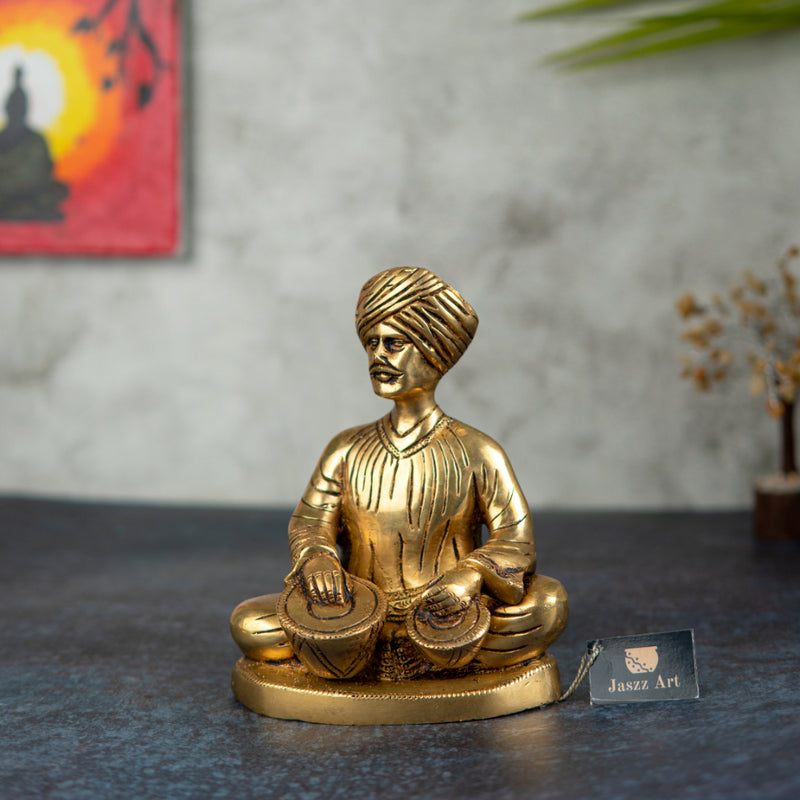 Brass Musician - intricately crafted brass statue of a musician playing a traditional instrument, golden finish, captures the beauty and rhythm of music, adds an artistic and cultural touch to your home decor, symbolizes the power of expression and creativity, perfect for music lovers and collectors, a unique and captivating addition to your collection of brass sculptures and figurines, ideal for music rooms, studios, or as a gift for musicians and enthusiasts