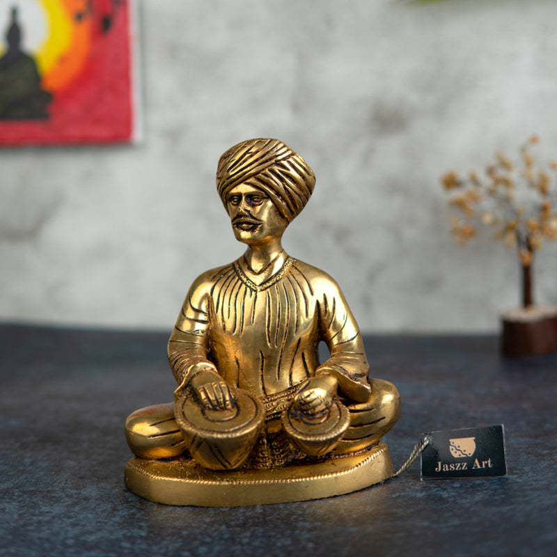 Brass Musician - intricately crafted brass statue of a musician playing a traditional instrument, golden finish, captures the beauty and rhythm of music, adds an artistic and cultural touch to your home decor, symbolizes the power of expression and creativity, perfect for music lovers and collectors, a unique and captivating addition to your collection of brass sculptures and figurines, ideal for music rooms, studios, or as a gift for musicians and enthusiasts