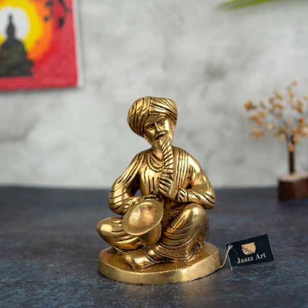 Brass Musician - intricately crafted brass statue of a musician playing a traditional instrument, golden finish, captures the beauty and rhythm of music, adds an artistic and cultural touch to your home decor, symbolizes the power of expression and creativity, perfect for music lovers and collectors, a unique and captivating addition to your collection of brass sculptures and figurines, ideal for music rooms, studios, or as a gift for musicians and enthusiasts