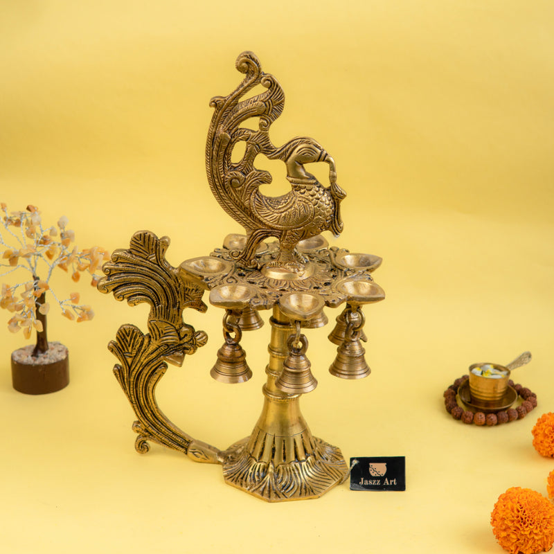 Brass peacock parrot Diya - exquisitely crafted brass oil lamp in the shape of a peacock with parrot motifs, golden finish, decorative home accent, fusion of elegance and vibrancy, traditional Indian Diya, emits a captivating and auspicious glow, perfect for festive occasions and religious ceremonies, enhances spiritual ambiance and decor with a touch of artistic brilliance.